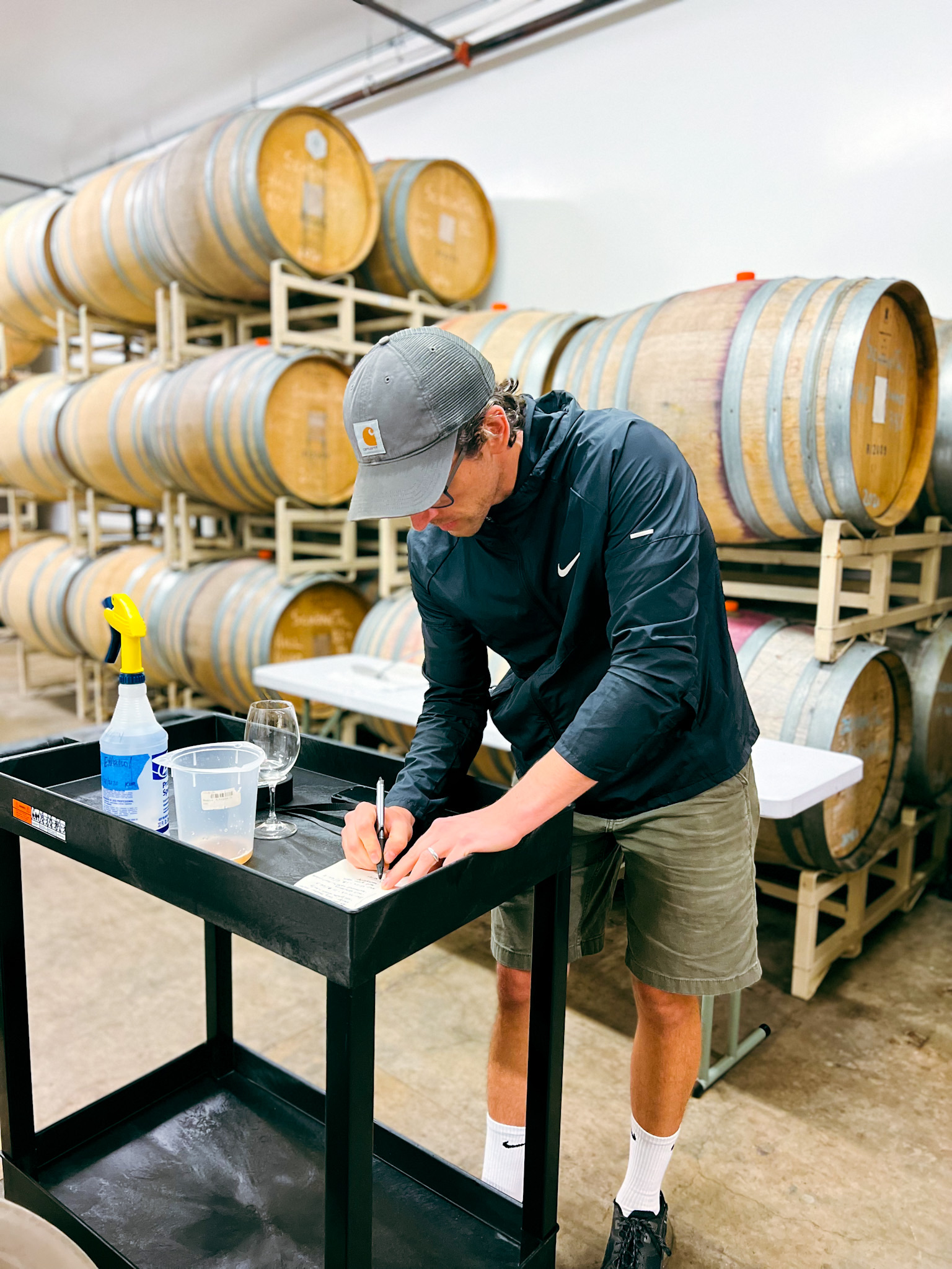 Kenny evaluating wines in the cellar to track fermentation