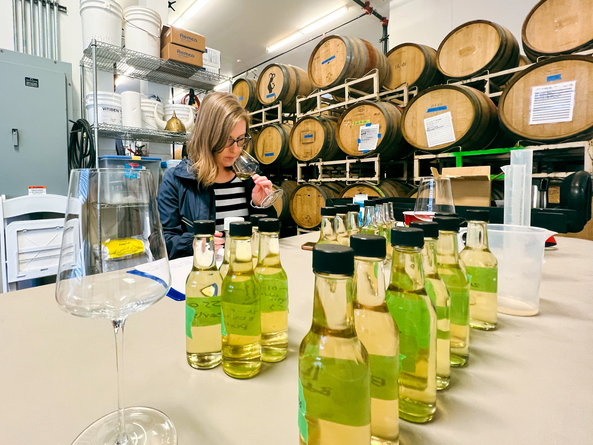 Allison evaluating barrels during blending trials before sparkling wine bottling