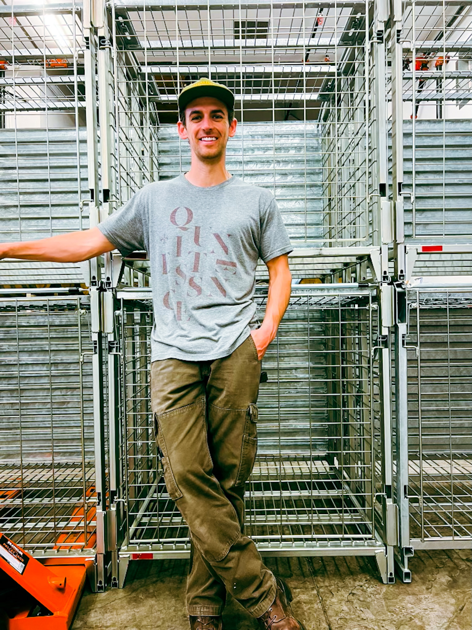 Kenny in front of sparkling wine cages used for riddling